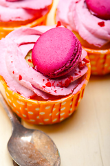 Image showing pink berry cream cupcake with macaroon on top