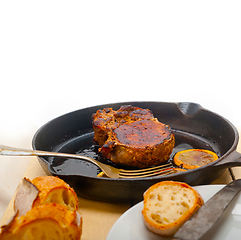 Image showing pork chop seared on iron skillet