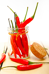 Image showing red chili peppers on a glass jar