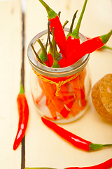 Image showing red chili peppers on a glass jar