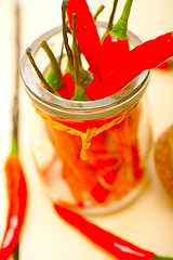 Image showing red chili peppers on a glass jar