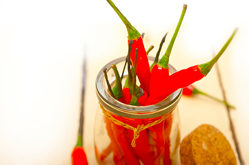 Image showing red chili peppers on a glass jar