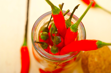 Image showing red chili peppers on a glass jar