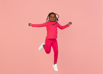 Image showing Handsome african little girl portrait isolated on pink studio background with copyspace