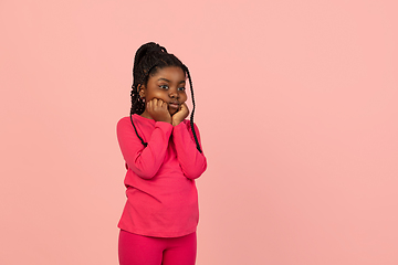 Image showing Handsome african little girl portrait isolated on pink studio background with copyspace