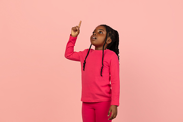 Image showing Handsome african little girl portrait isolated on pink studio background with copyspace