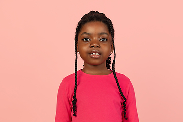 Image showing Handsome african little girl portrait isolated on pink studio background with copyspace