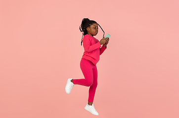 Image showing Handsome african little girl portrait isolated on pink studio background with copyspace