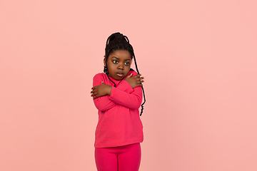 Image showing Handsome african little girl portrait isolated on pink studio background with copyspace