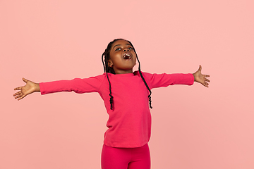 Image showing Handsome african little girl portrait isolated on pink studio background with copyspace