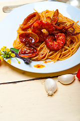 Image showing Italian seafood spaghetti pasta on red tomato sauce