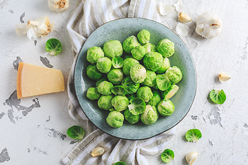 Image showing Raw Brussel sprouts with salt and Parmesan cheese in bowl