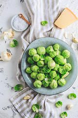 Image showing Raw Brussel sprouts with salt and Parmesan cheese in bowl