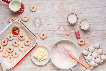 Image showing Homemade Christmas cookies with baking ingredients in white