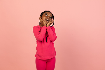 Image showing Handsome african little girl portrait isolated on pink studio background with copyspace