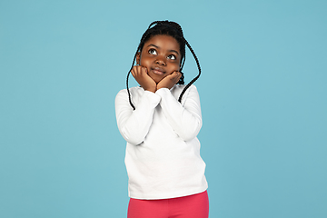 Image showing Handsome african little girl portrait isolated on blue studio background with copyspace