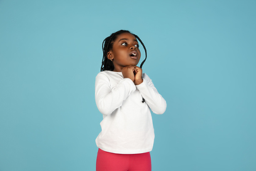 Image showing Handsome african little girl portrait isolated on blue studio background with copyspace