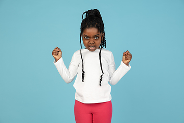 Image showing Handsome african little girl portrait isolated on blue studio background with copyspace