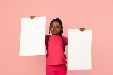 Image showing Handsome african little girl portrait isolated on pink studio background with copyspace