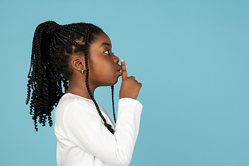 Image showing Handsome african little girl portrait isolated on blue studio background with copyspace