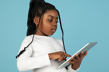 Image showing Handsome african little girl portrait isolated on blue studio background with copyspace