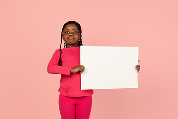 Image showing Handsome african little girl portrait isolated on pink studio background with copyspace