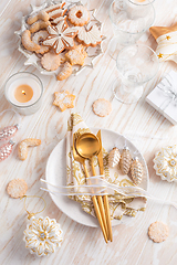 Image showing Place setting and Christmas table decorated with ornaments, gingerbread and cookies