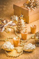 Image showing Christmas ornaments, present box and candles in golden tones