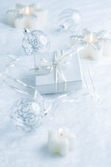 Image showing Christmas ornaments, candles and small present in white