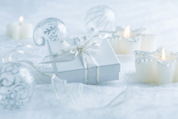 Image showing Christmas ornaments, candles and small present in white