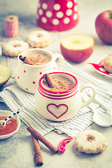 Image showing Winter hot drink. Hot chocolate or cocoa with spices, cookies and fresh apple