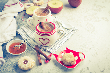 Image showing Winter hot drink. Hot chocolate or cocoa with spices, cookies and fresh apple