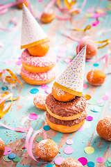 Image showing Krapfen, Berliner and donuts with streamers and confetti. Colorful carnival or birthday image