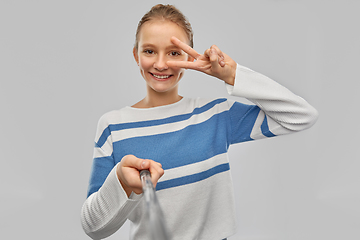 Image showing happy teenage gir taking selfie and showing peace