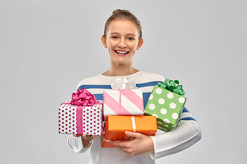 Image showing smiling teenage girl in pullover with gift box