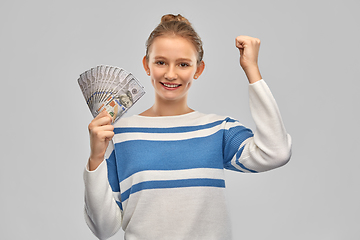 Image showing smiling teenage girl with dollar money banknotes