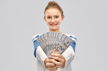 Image showing smiling teenage girl with dollar money banknotes