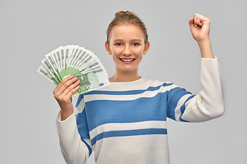 Image showing smiling teenage girl with euro money banknotes