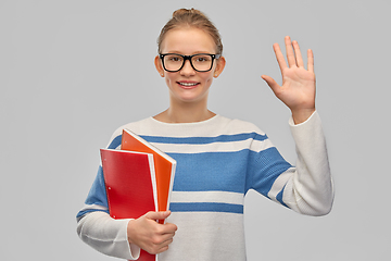 Image showing happy smiling teenage student girl with notebooks