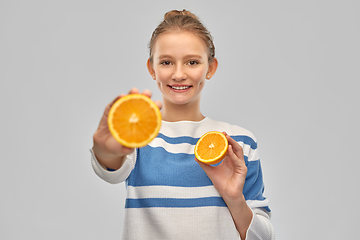 Image showing smiling teenage girl in pullover with oranges