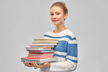 Image showing happy smiling teenage student girl with books