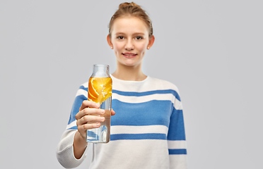 Image showing teenage girl with glass bottle of fruit water