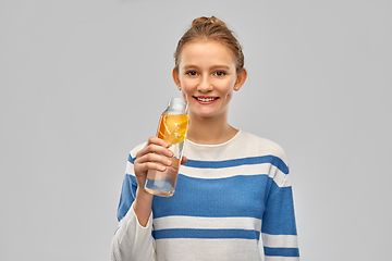 Image showing teenage girl with glass bottle of fruit water
