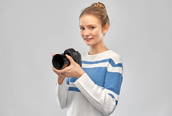 Image showing smiling teenage girl r with digital camera