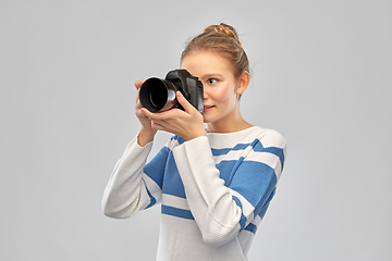 Image showing smiling teenage girl r with digital camera