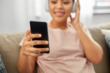 Image showing woman with smartphone listening to music at home