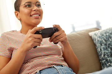 Image showing african american woman with gamepad playing game