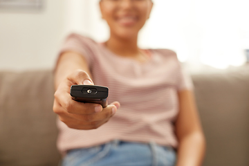 Image showing happy african american woman watching tv at home