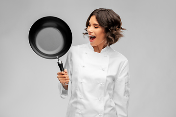 Image showing smiling female chef in toque with frying pan