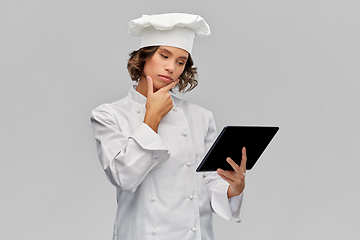 Image showing female chef in toque with tablet computer